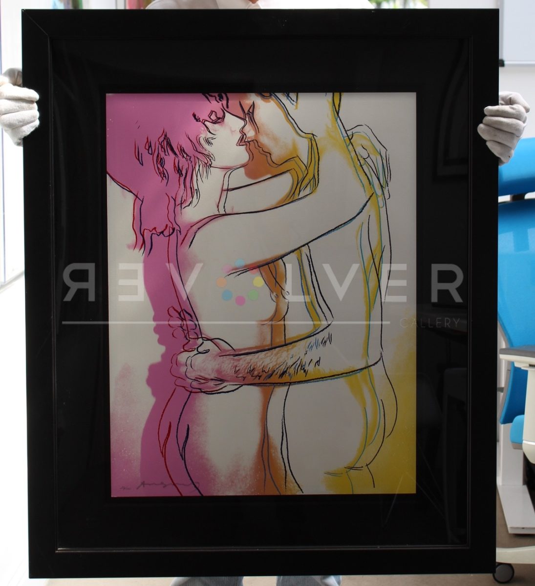 Andy Warhol Love 312 screenprint framed and being held by someone wearing white gloves.