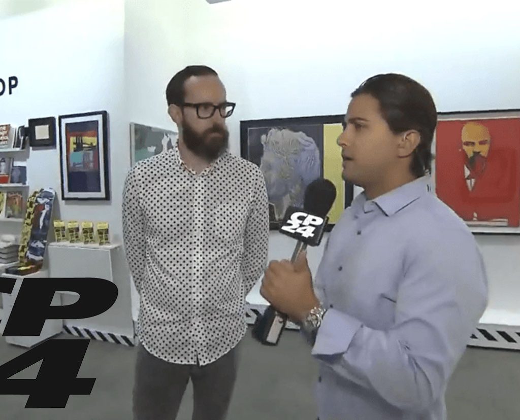 Revolver Gallery director with interviewer for Andy Warhol Revisited on CP24, 2015.