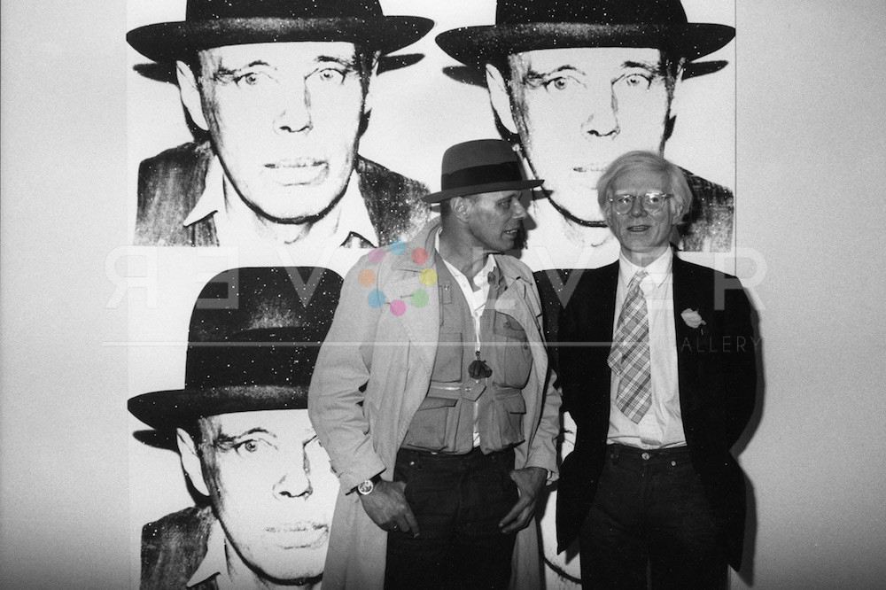 Joseph Beuys and Andy Warhol standing in front of the "Joseph Beuys" artwork at an art gallery.
