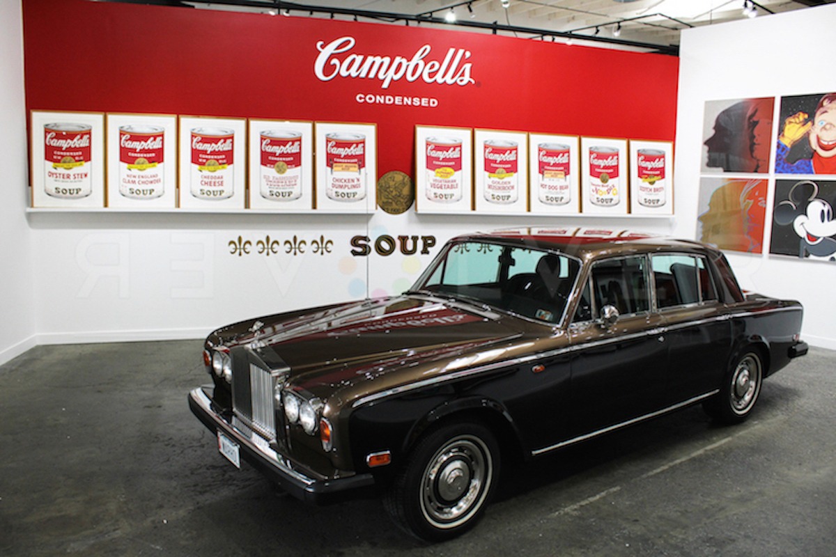 Andy Warhol's Campbell's Soup Cans II complete portfolio of prints hanging above his Rolls Royce, inside revolver gallery.