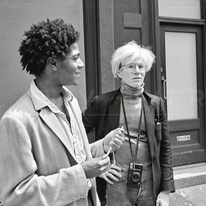 Jean-Michel Basquiat and Andy Warhol standing on the streets of New York in Black and White.