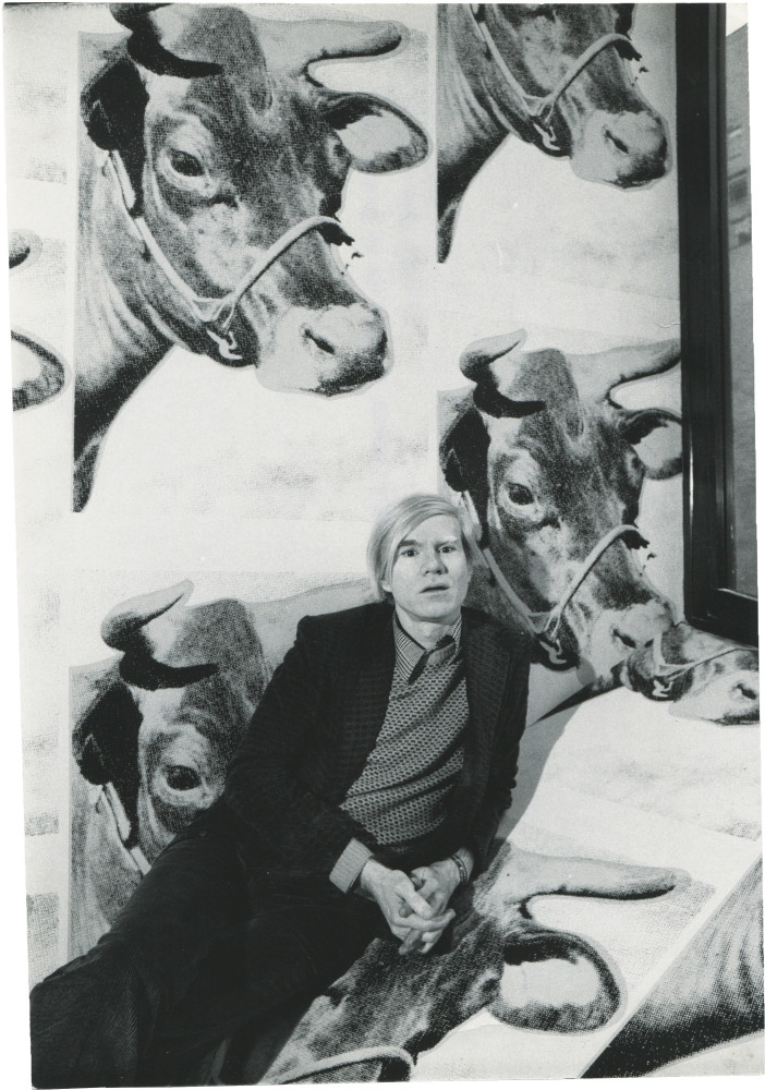 Warhol standing in front of his Cow Wallpaper