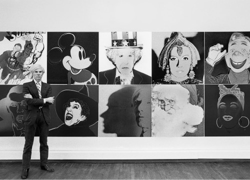Warhol standing with his Myths portfolio