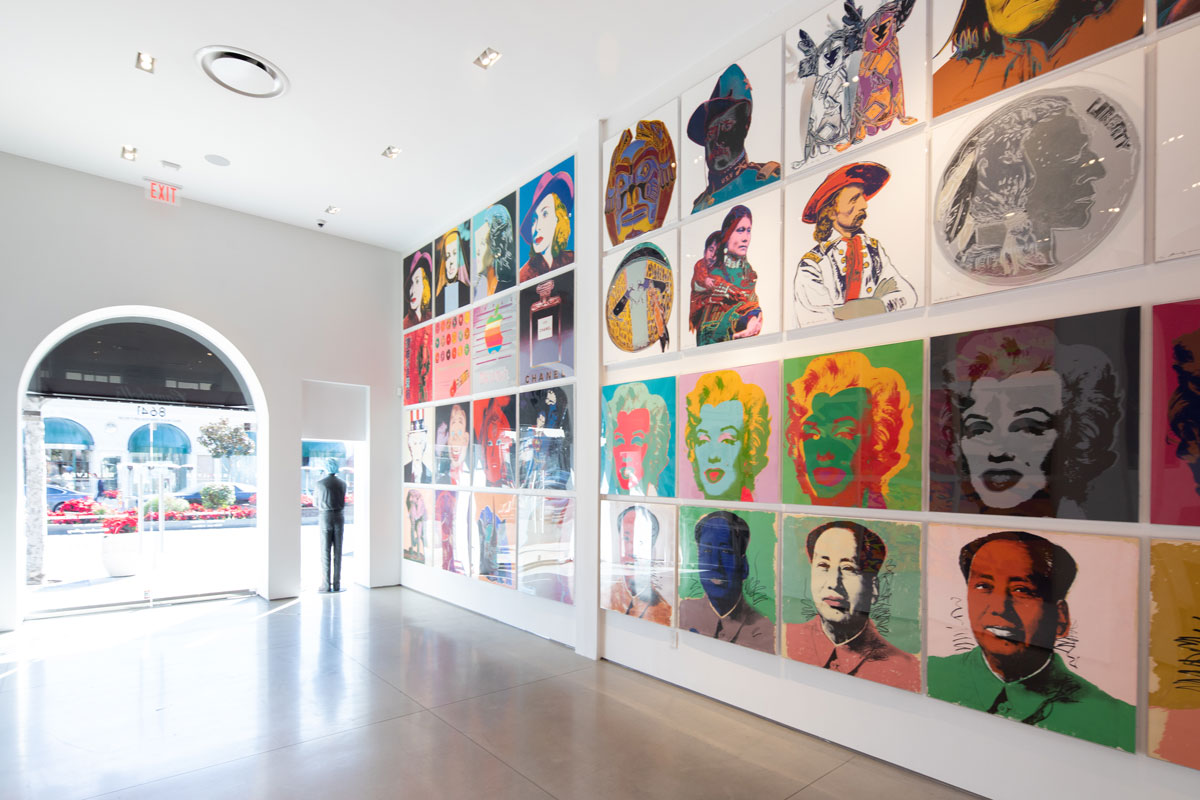 Inside of Revolver Gallery, Mao, Marilyn Monroe, Cowboys and Indians, Myths, Ads, and Ingrid Bergman screen prints on gallery wall.