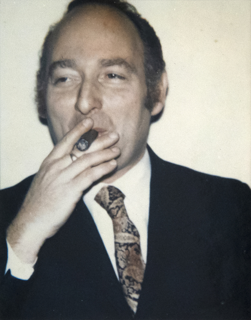 Polaroid photograph of Ivan Karp smoking a cigar, by Andy Warhol.