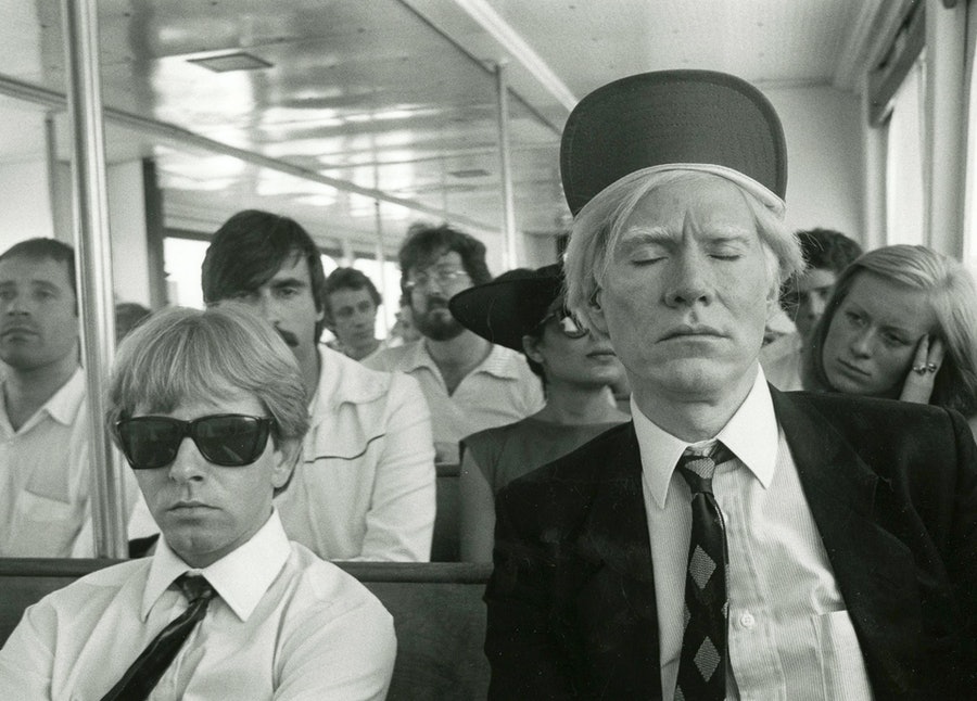 Rupert Jasen Smith sitting with Andy Warhol on a bus