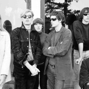 Andy Warhol posing with the Velvet Underground