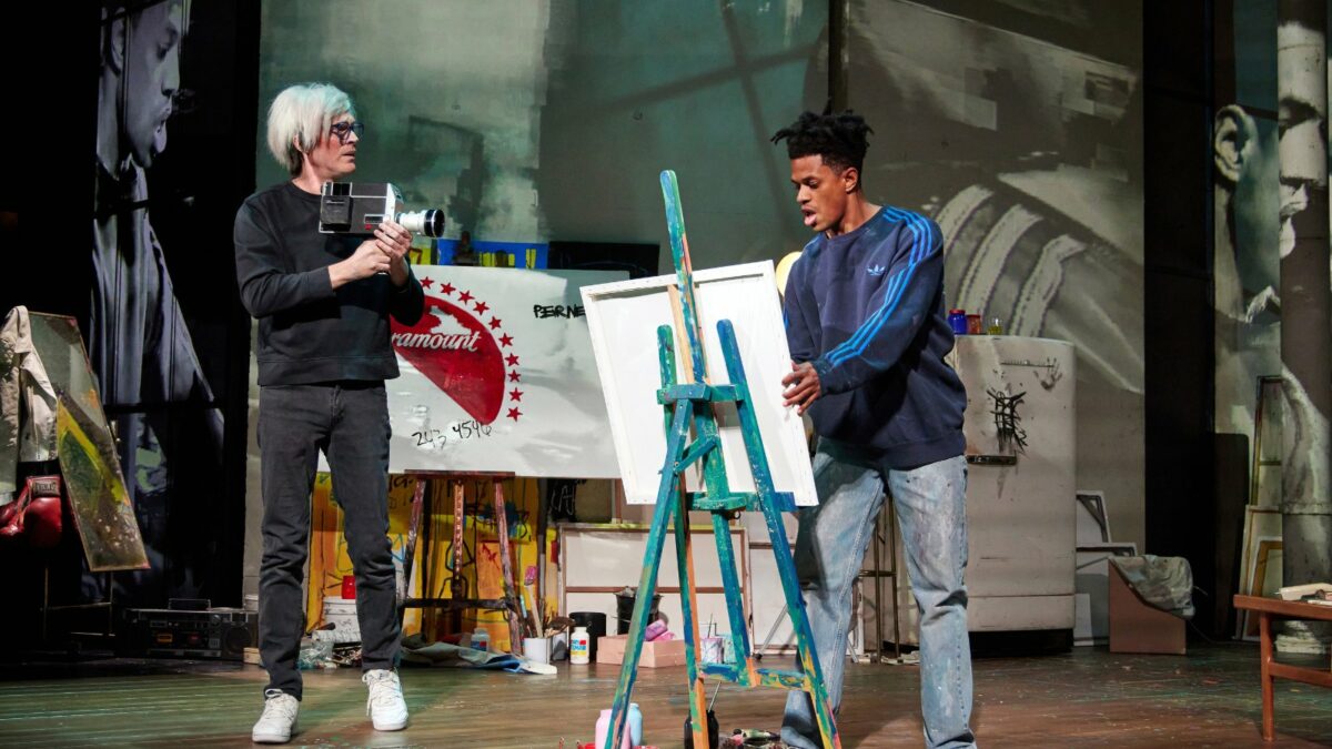 Actors Paul Bettany and Jeremy Pope on stage playing Andy Warhol and Jean-Michel Basquiat in the play "The Collaboration."