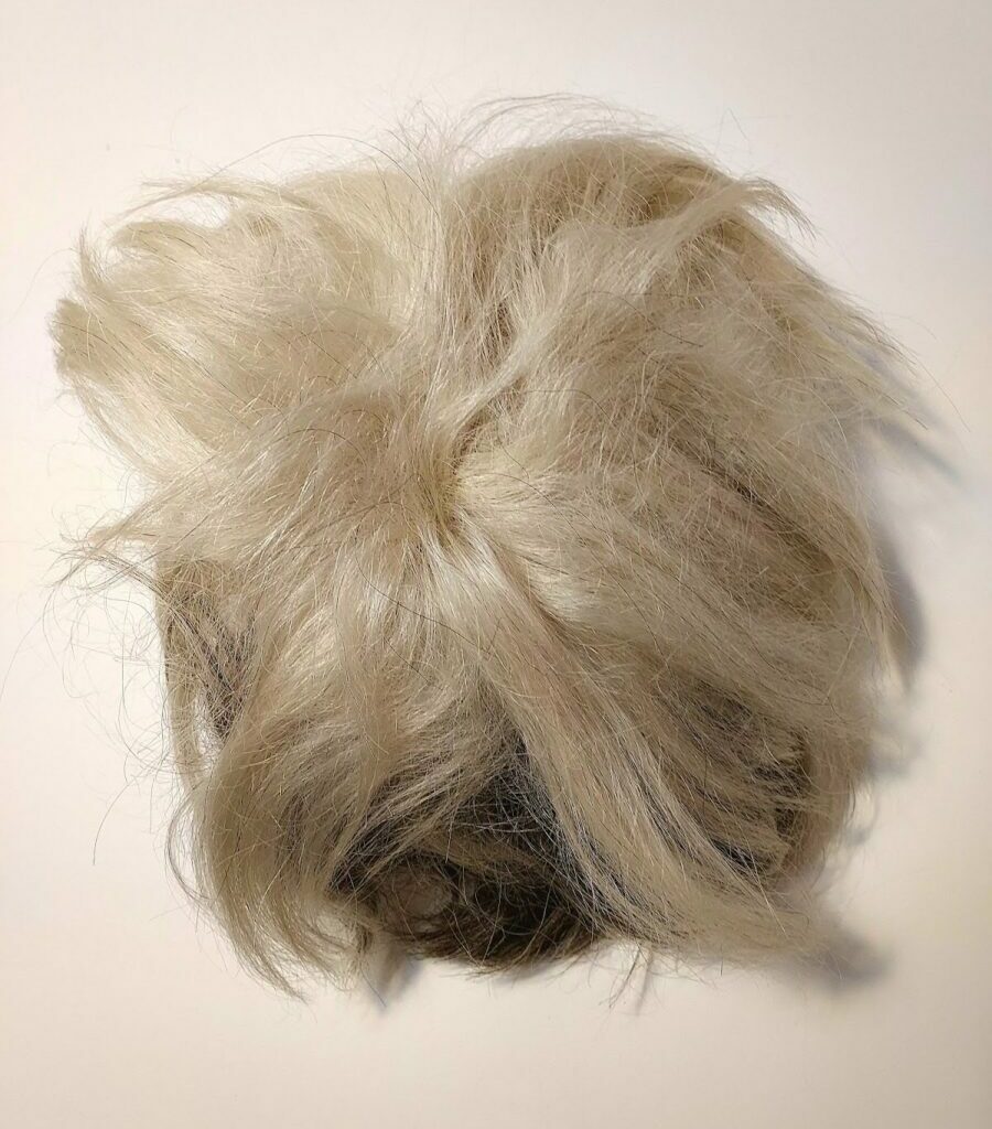 Andy Warhol's "Death Wig" laying on a table.